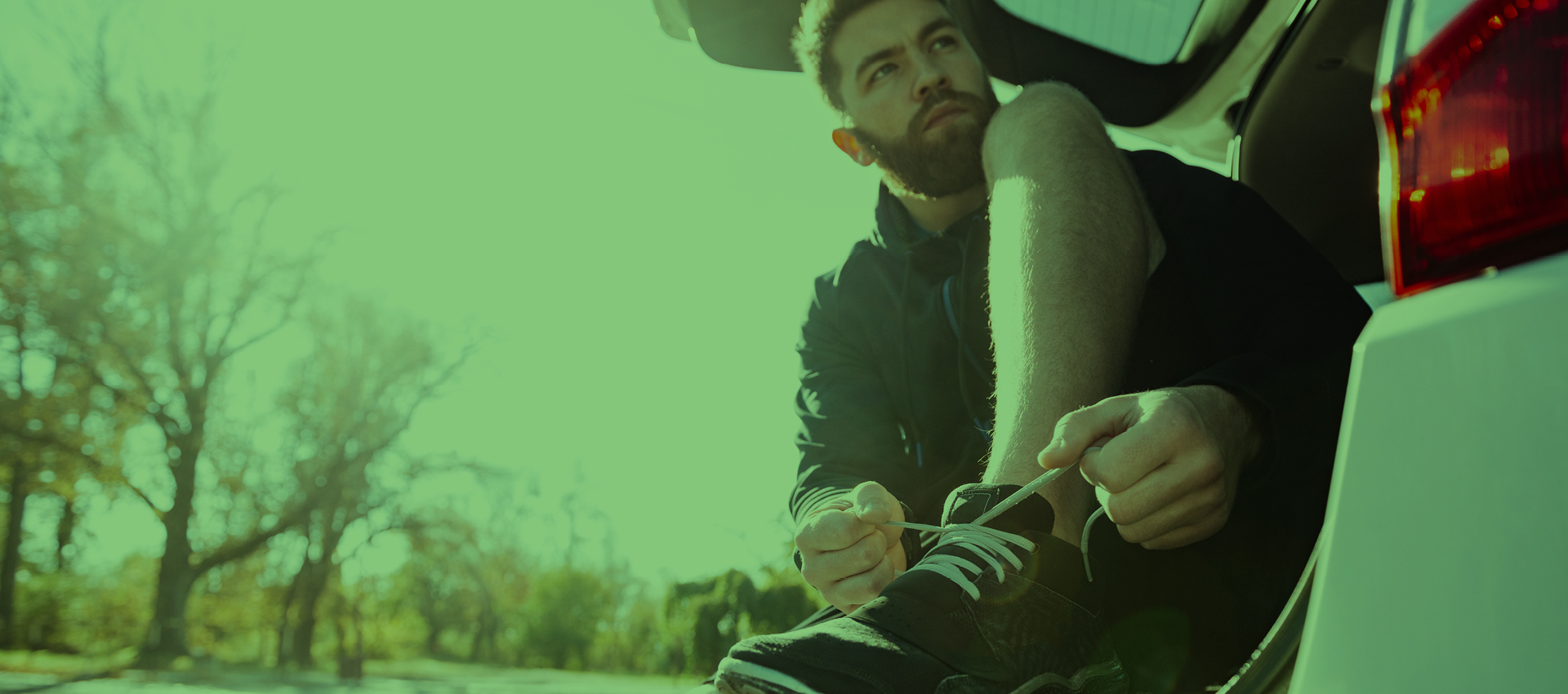 employee tying shoelace on ute
