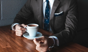 suited exec drinking coffee