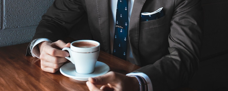 suited exec drinking coffee
