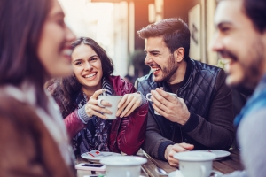 Happy young people having drinks outdoors