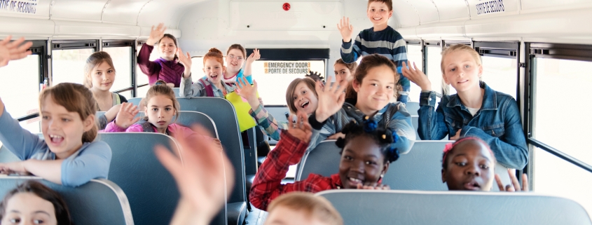 Students inside a school bus at the school's out