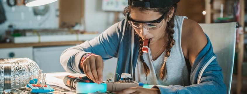 Girl working on some engineering project at home.
