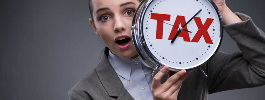 woman hold a tax clock