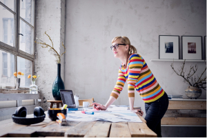 woman standing at office desk window