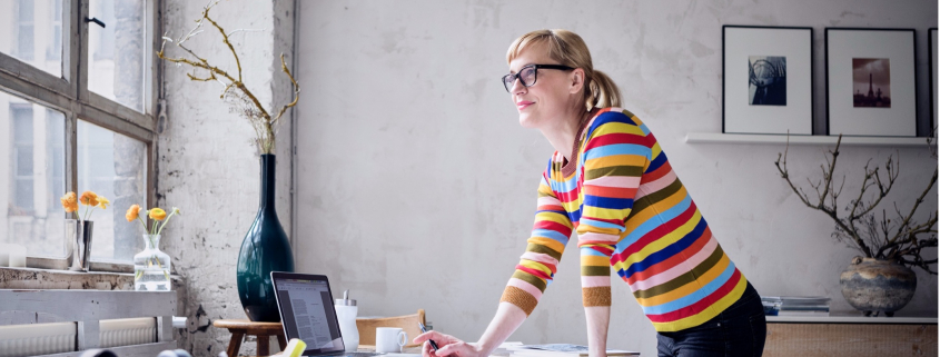 woman standing at office desk window